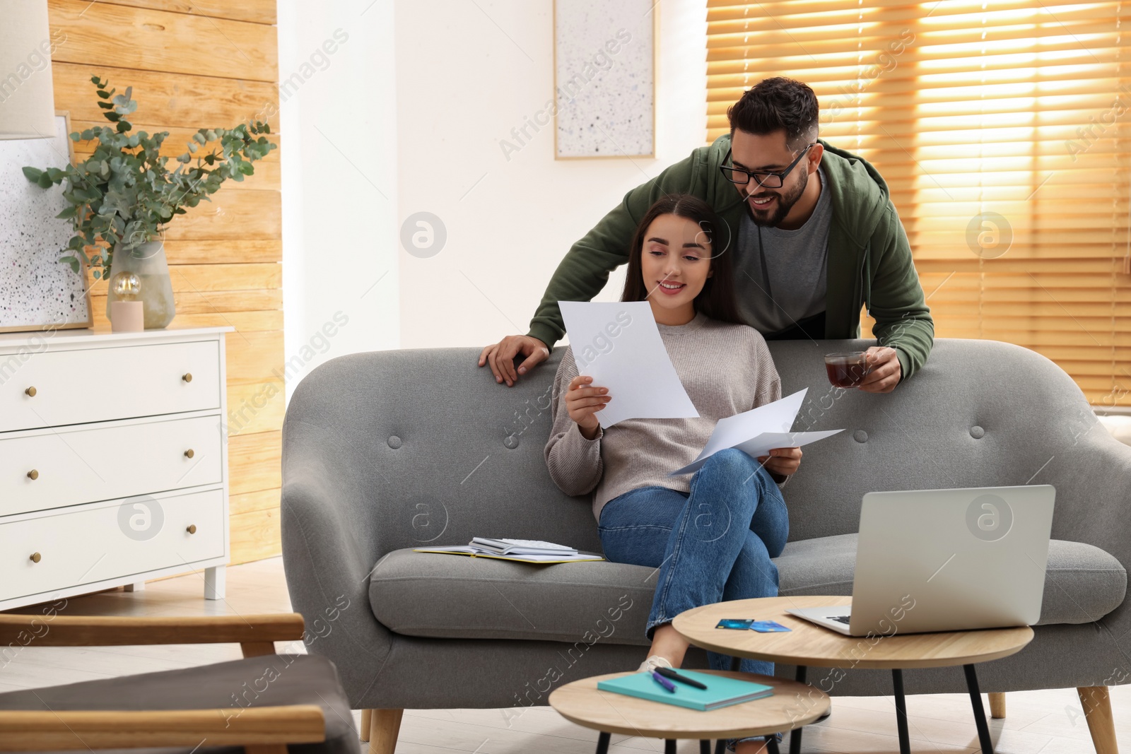 Photo of Young couple discussing family budget at home