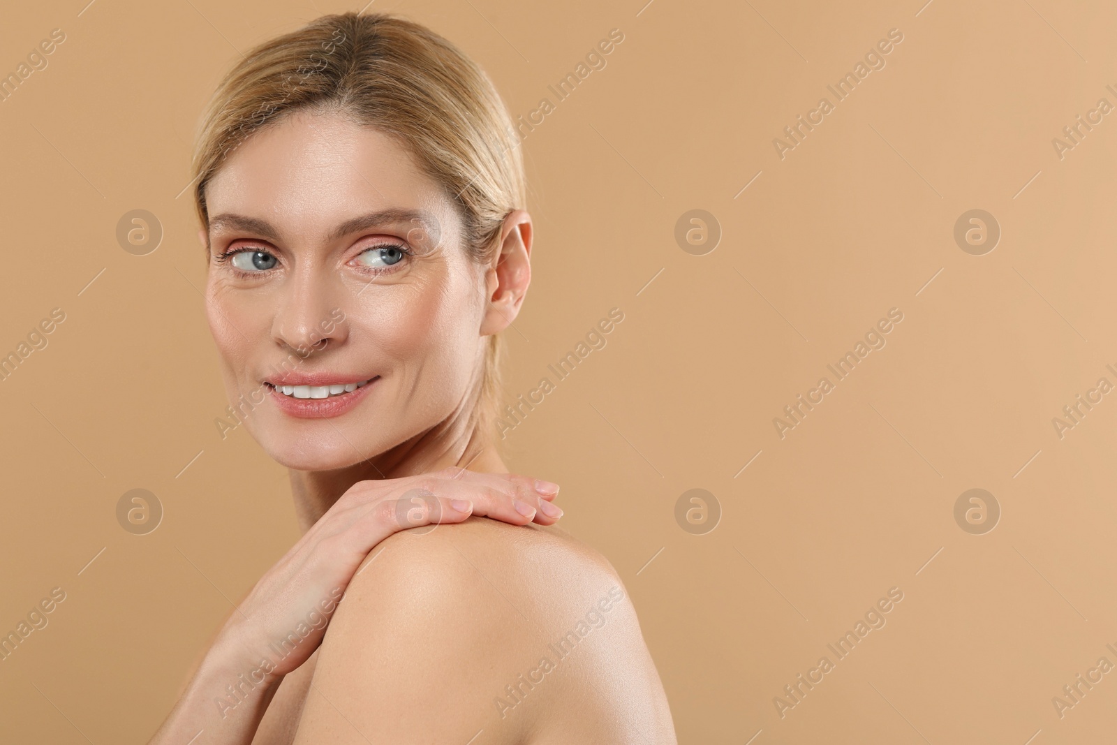 Photo of Beautiful woman with healthy skin on beige background, space for text