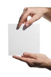 Man holding sheet of paper on white background, closeup. Mockup for design