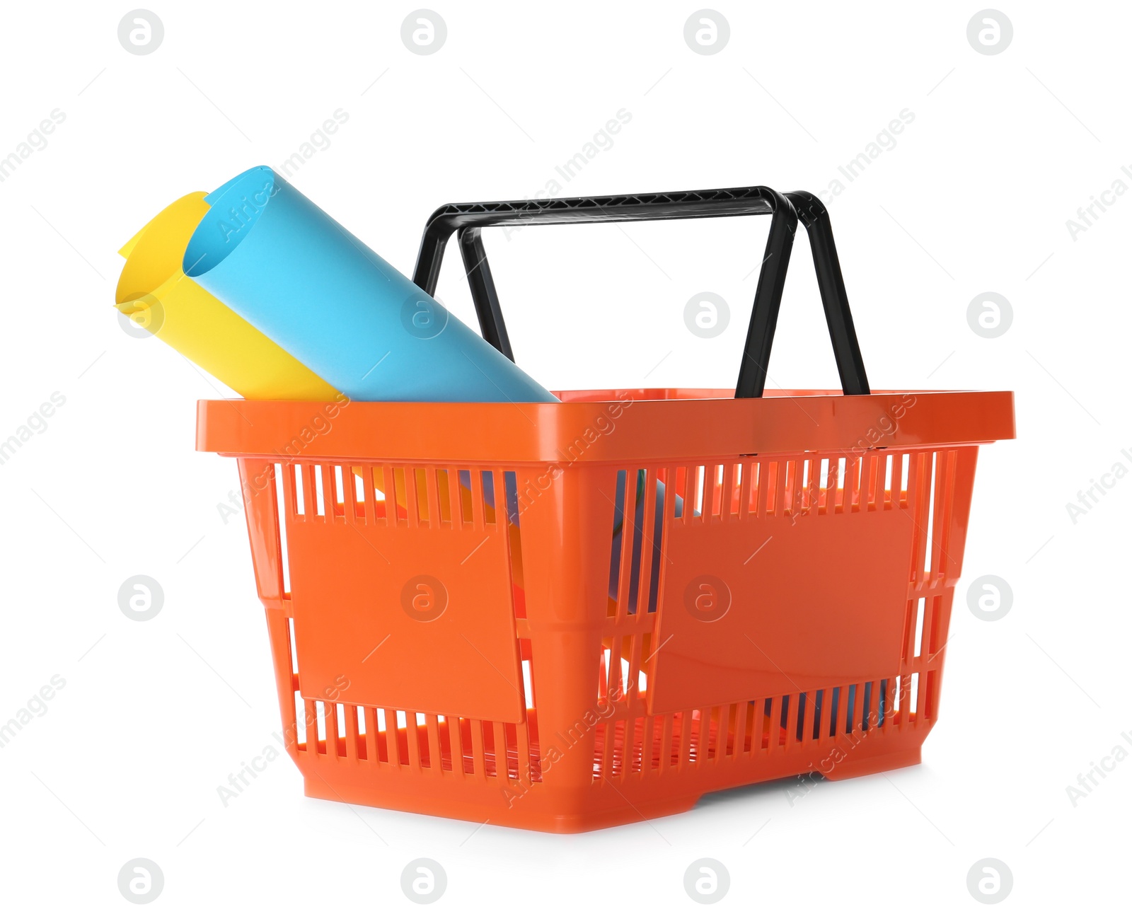 Photo of Color plastic shopping basket with rolls of paper isolated on white