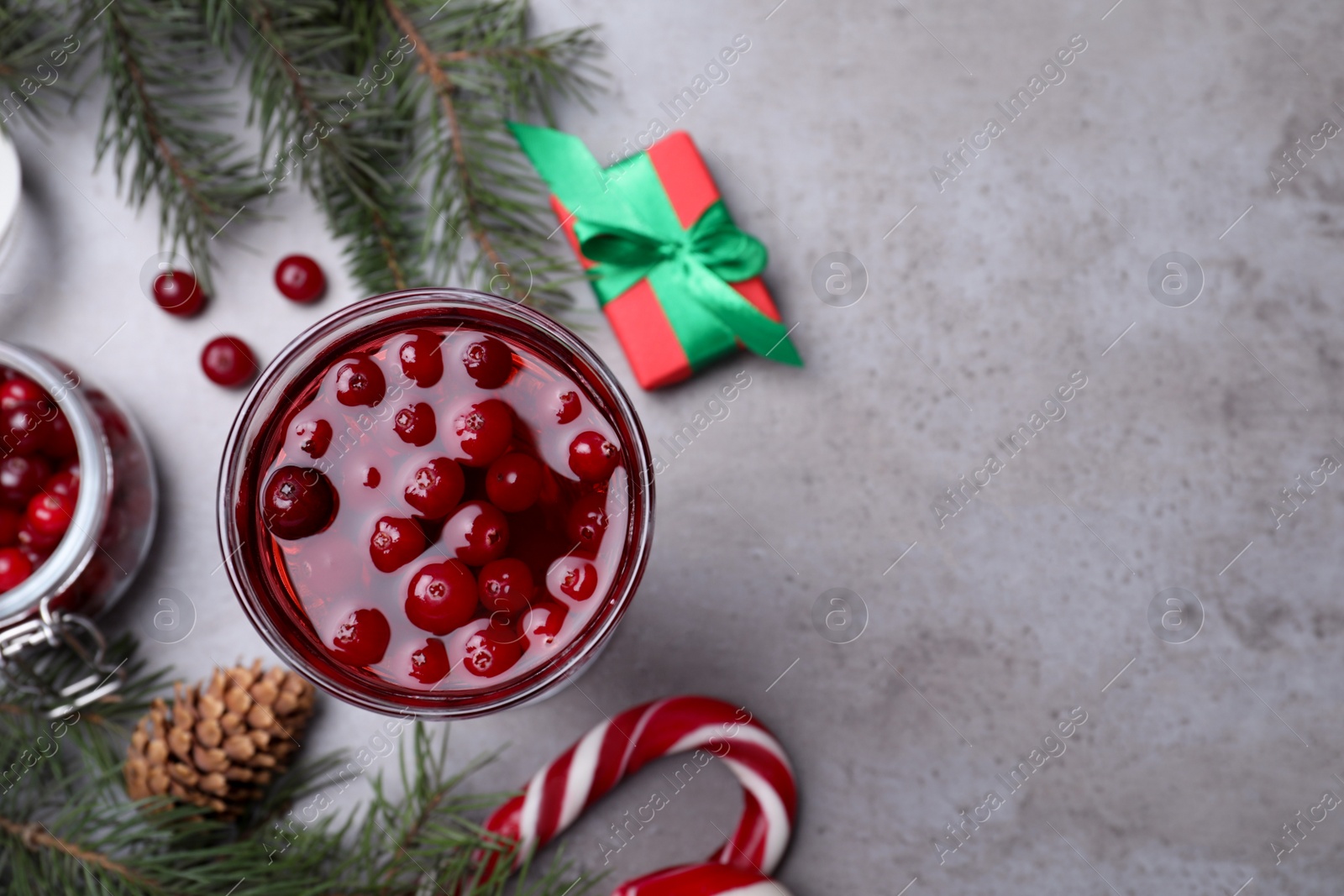 Photo of Flat lay composition with delicious Christmas liqueur on grey table, space for text