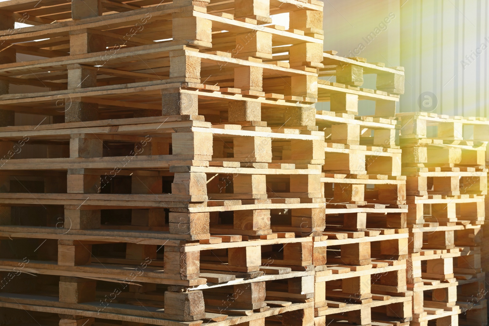 Image of Many empty wooden pallets stacked in warehouse