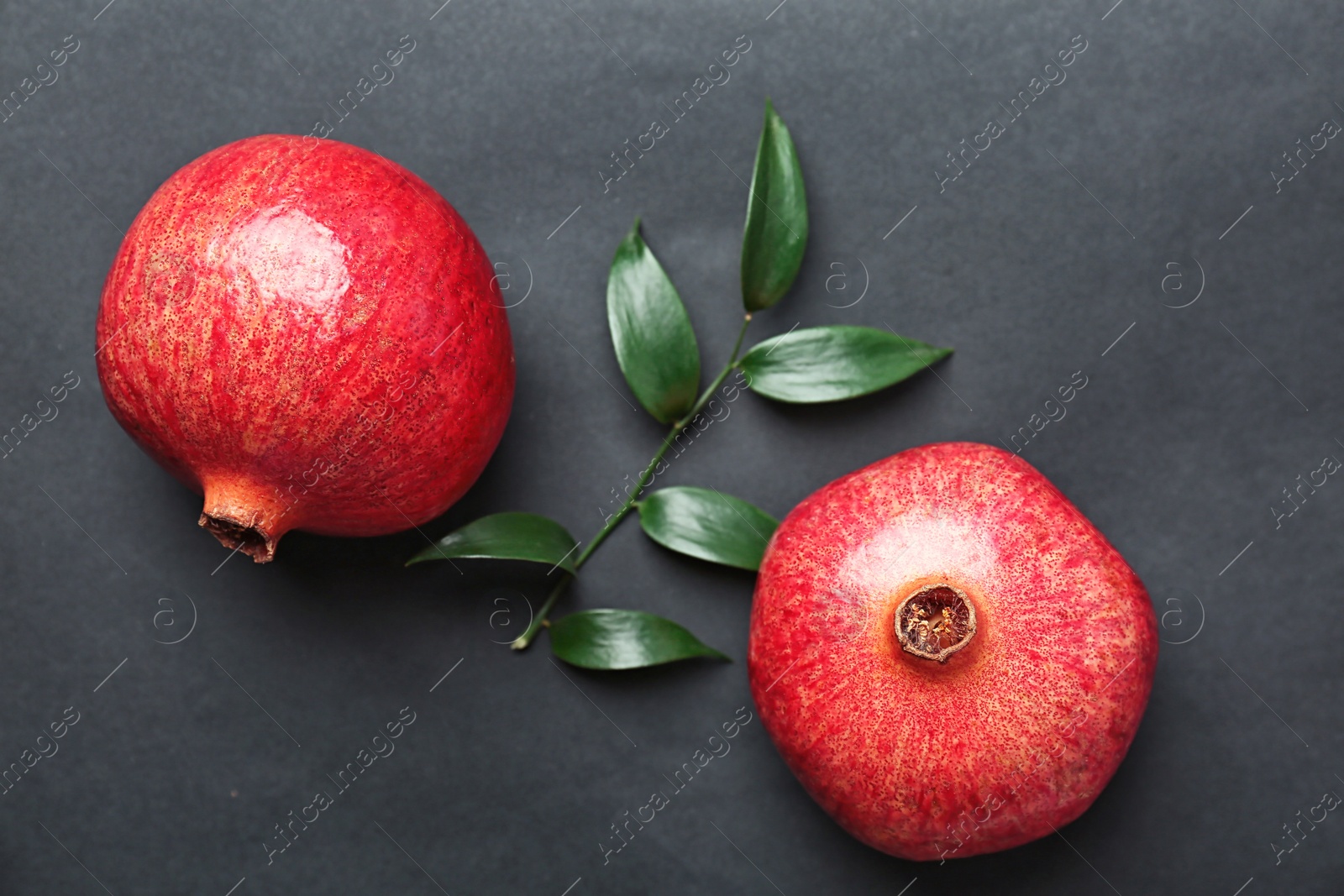 Photo of Fresh yummy pomegranates on dark table