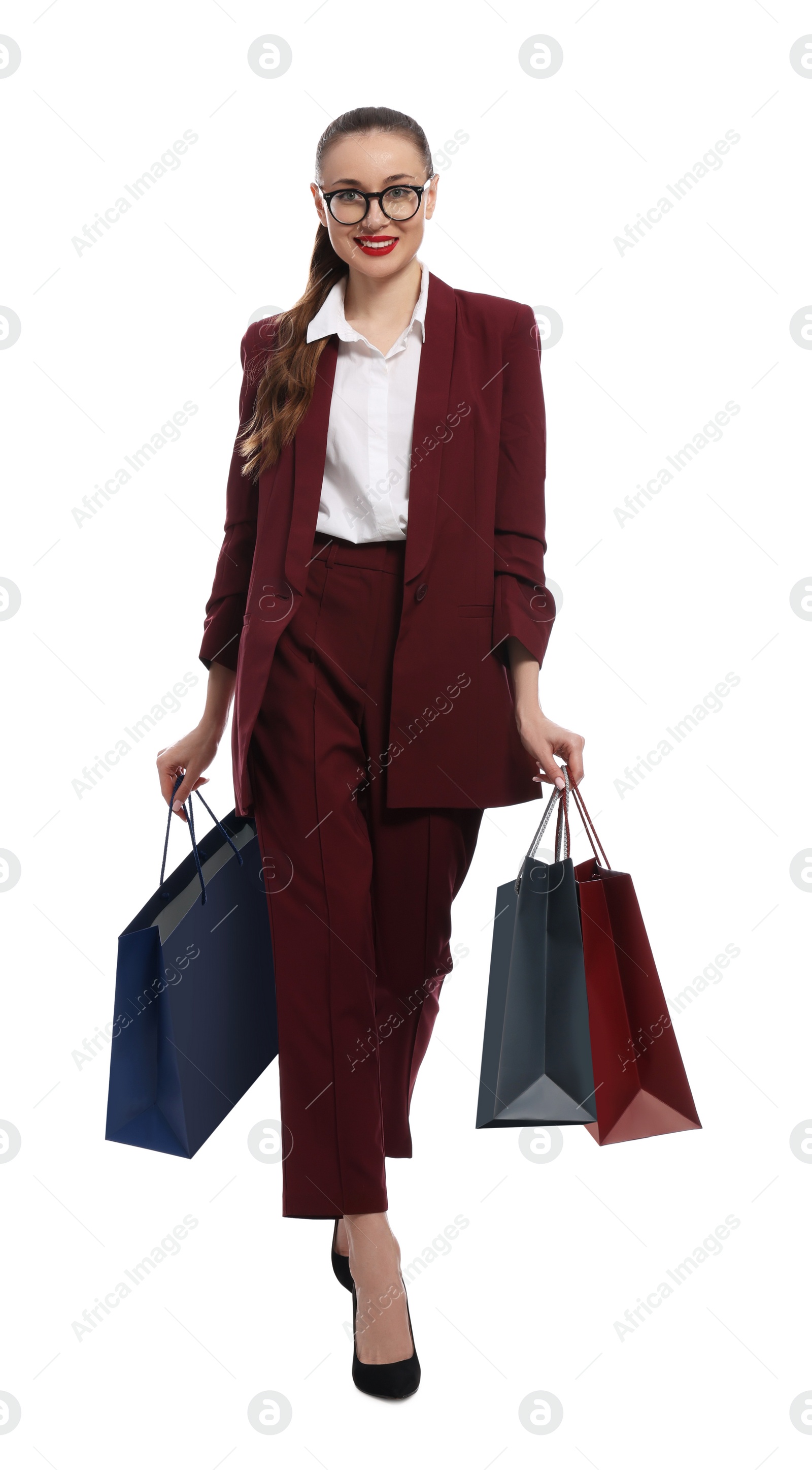 Photo of Stylish young businesswoman with shopping bags on white background