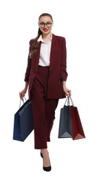 Stylish young businesswoman with shopping bags on white background