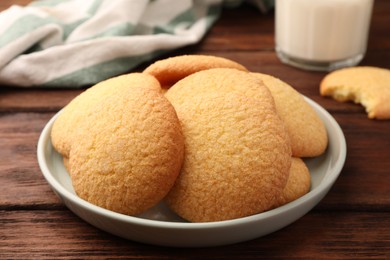 Photo of Delicious Danish butter cookies on wooden table, closeup