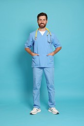 Photo of Full length portrait of doctor on light blue background