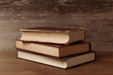 Image of Stack of old hardcover books on wooden table