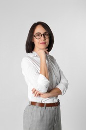 Portrait of mature businesswoman on light grey background