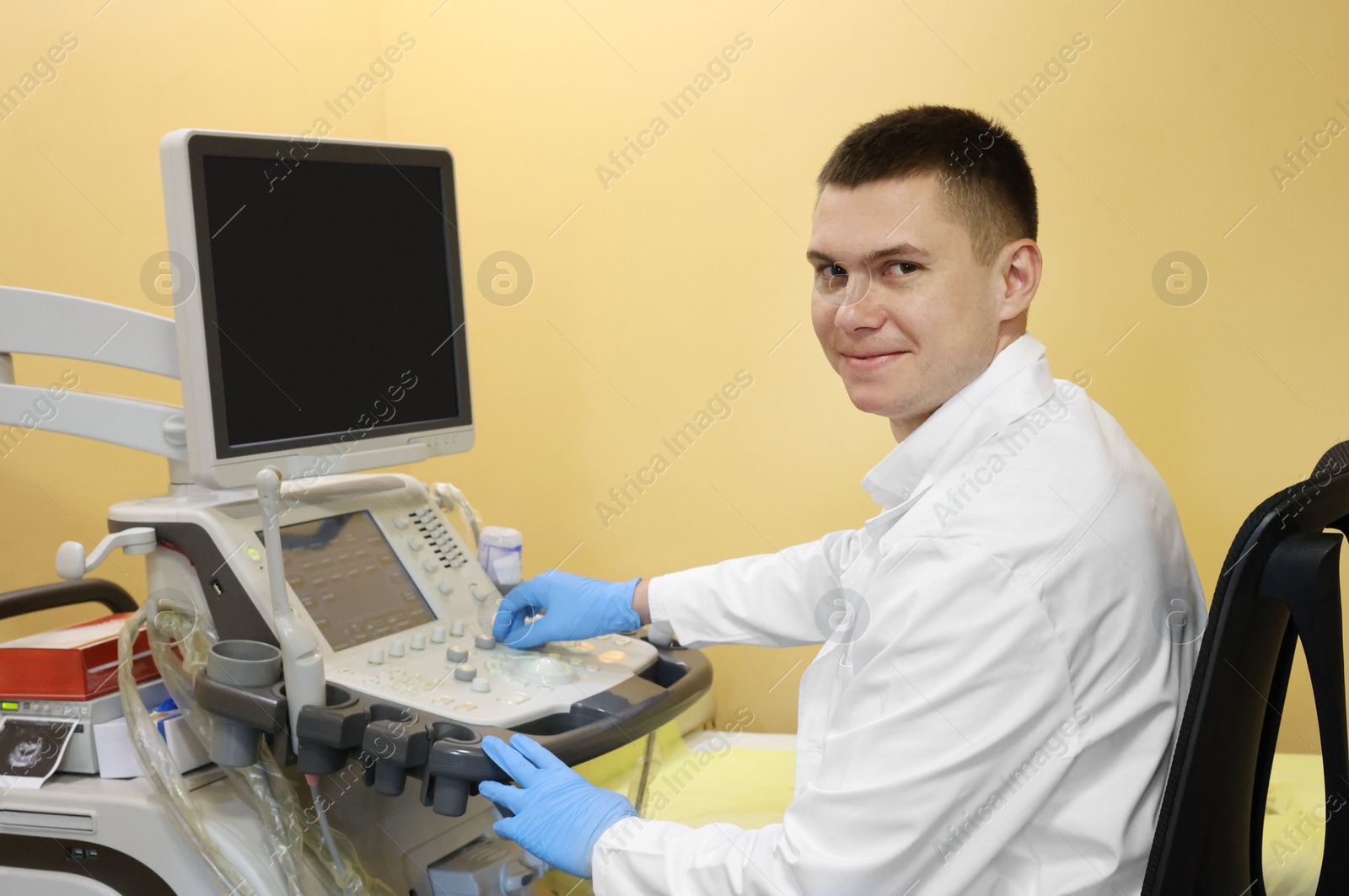 Photo of Doctor working with ultrasound machine in clinic