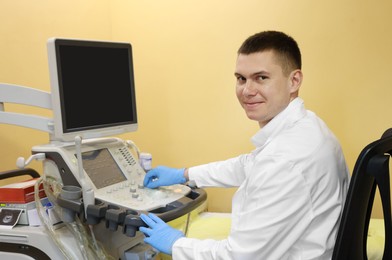 Doctor working with ultrasound machine in clinic