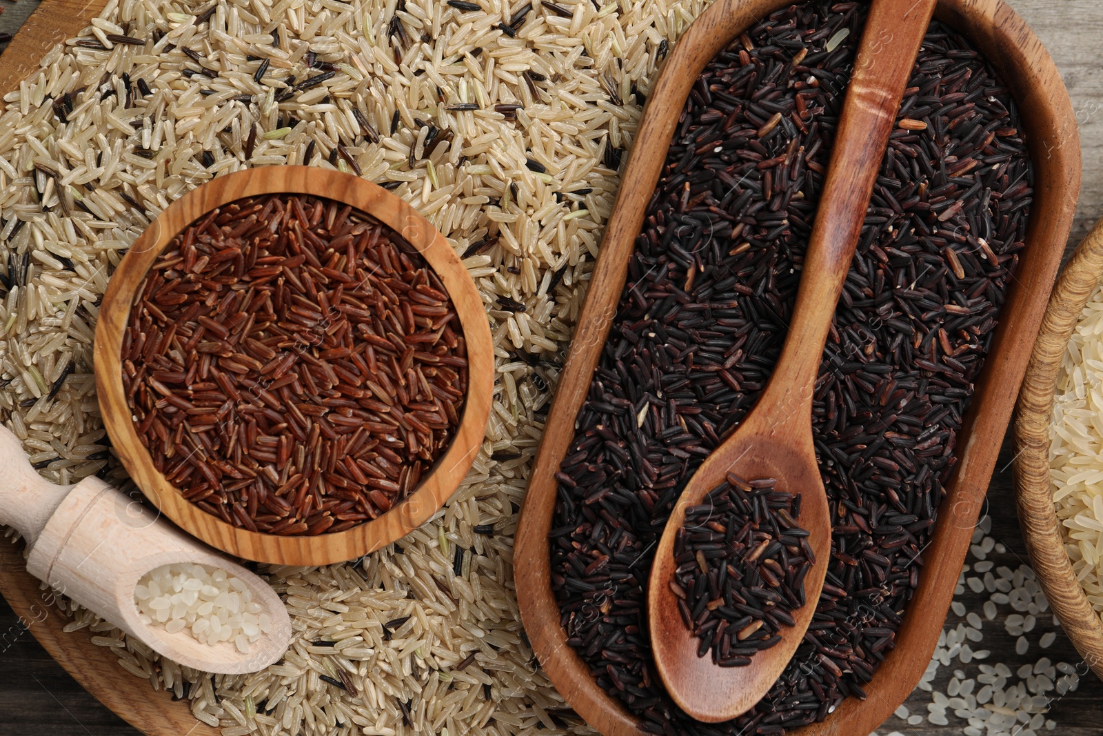 Photo of Different sorts of rice as background, top view