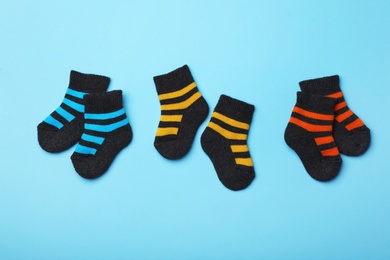 Cute child socks on color background, flat lay