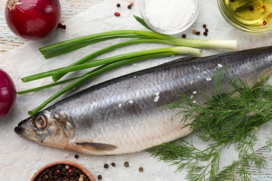 Photo of Delicious salted herring and ingredients on wooden table, flat lay