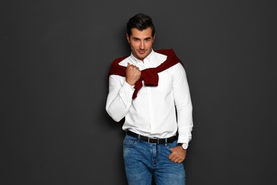 Portrait of handsome young man on dark background