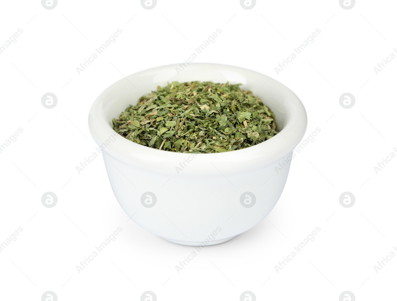 Image of Dry parsley in ceramic bowl on white background