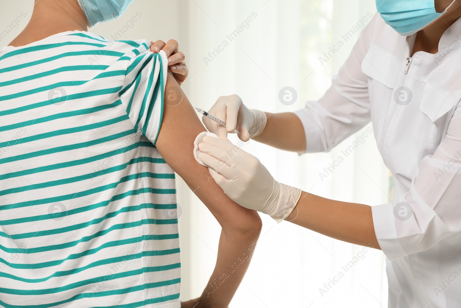 Photo of Doctor giving injection to patient in hospital, closeup. Vaccination day