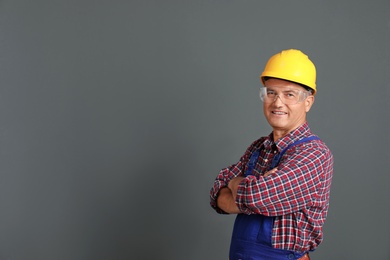 Photo of Portrait of electrician wearing uniform on gray background. Space for text