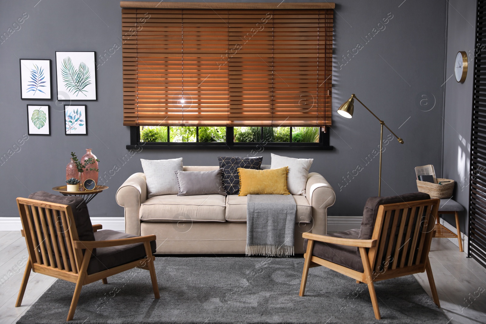 Photo of Stylish living room interior with comfortable sofa and armchairs