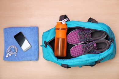 Flat lay composition with sports bag on floor, top view