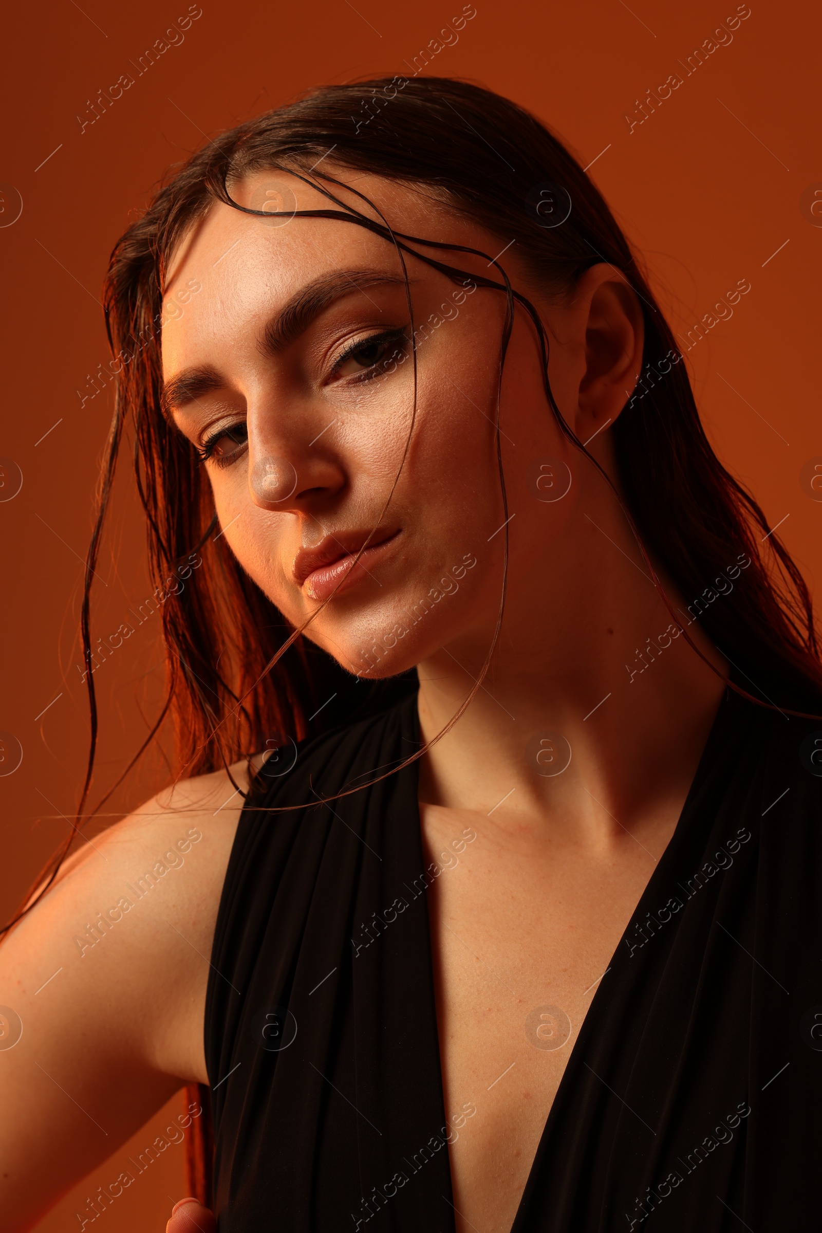 Photo of Portrait of beautiful woman on brown background