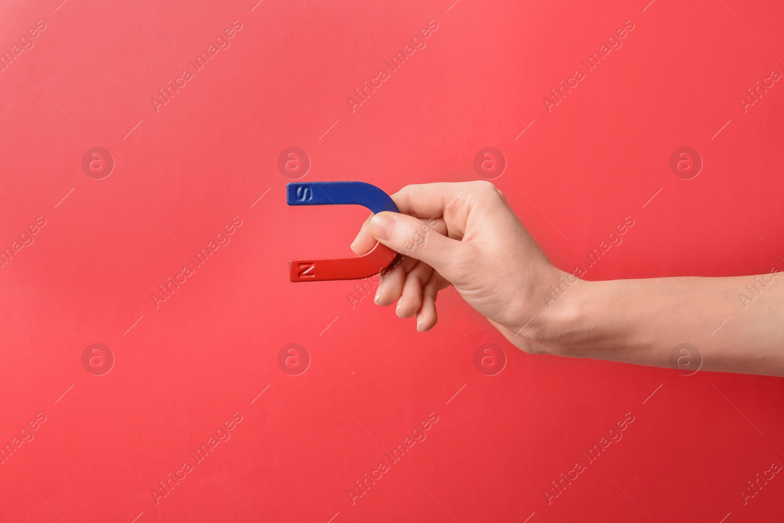 Photo of Woman holding magnet on color background, closeup. Space for text