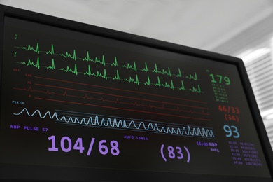 Photo of Black monitor with cardiogram in hospital, closeup