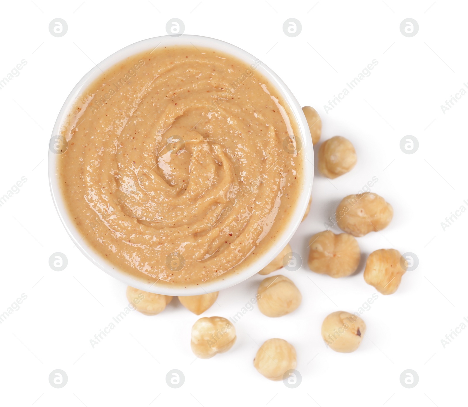 Photo of Delicious nut butter and hazelnuts isolated on white, top view