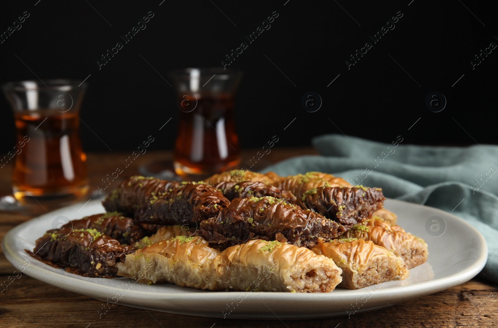 Photo of Delicious baklava with pistachios on wooden table