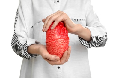 Photo of Woman holding model of heart on white background. Heart attack concept