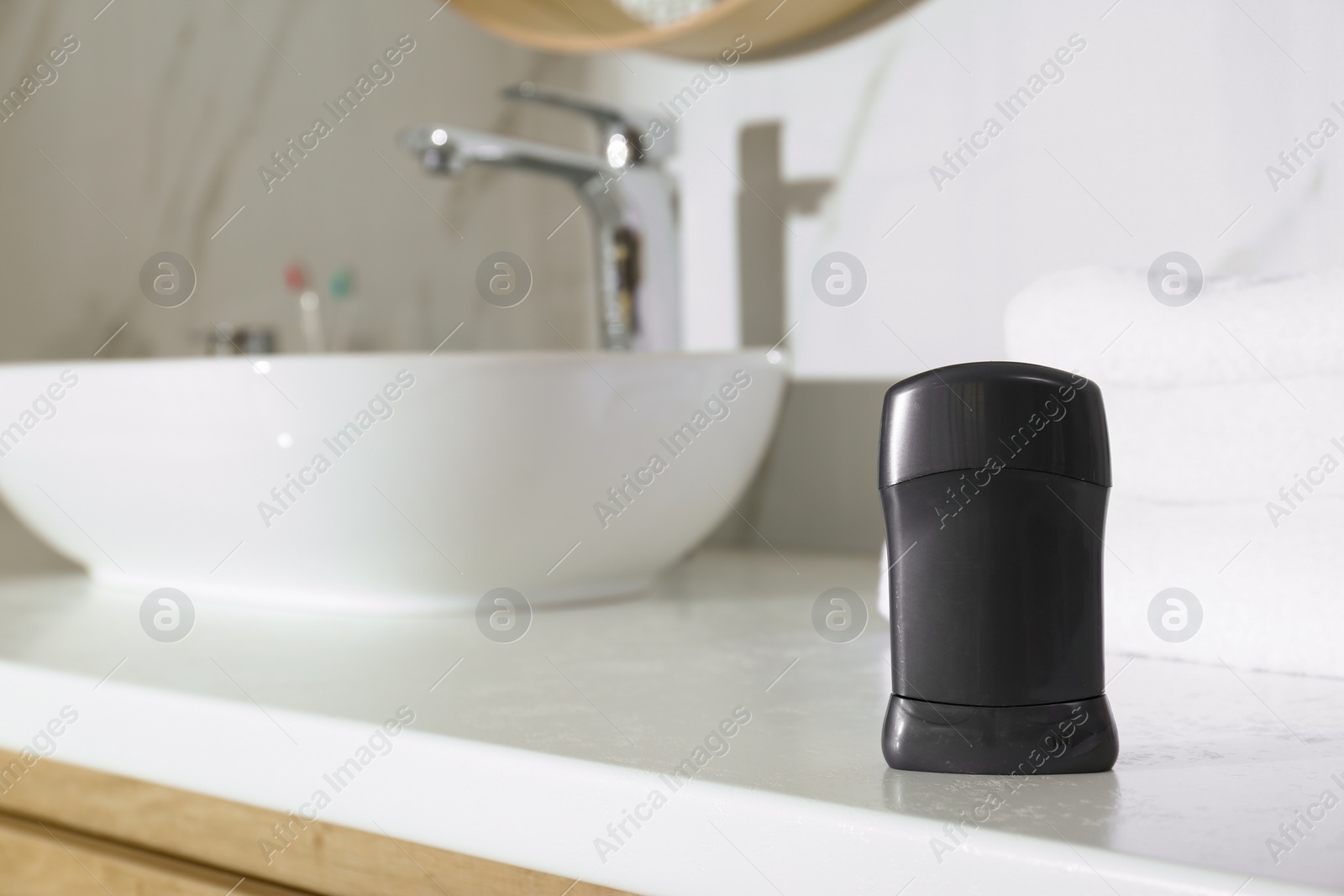 Photo of Deodorant container on light countertop in bathroom