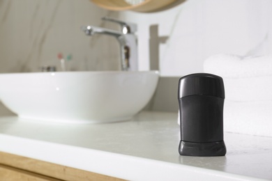 Photo of Deodorant container on light countertop in bathroom