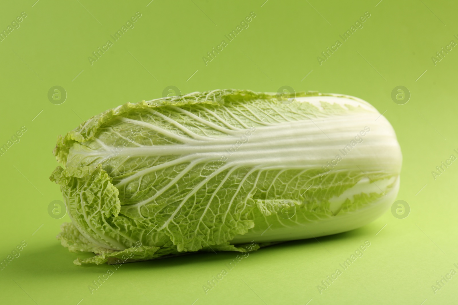 Photo of Fresh ripe Chinese cabbage on light green background