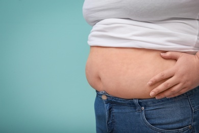 Photo of Overweight woman on color background