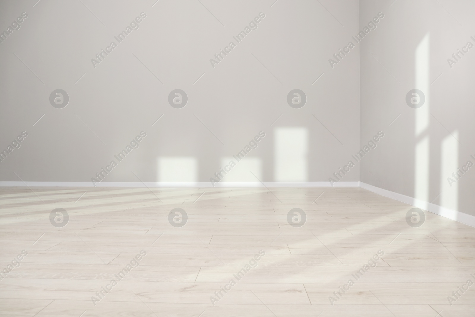 Photo of Light and shadows from window on floor and walls indoors