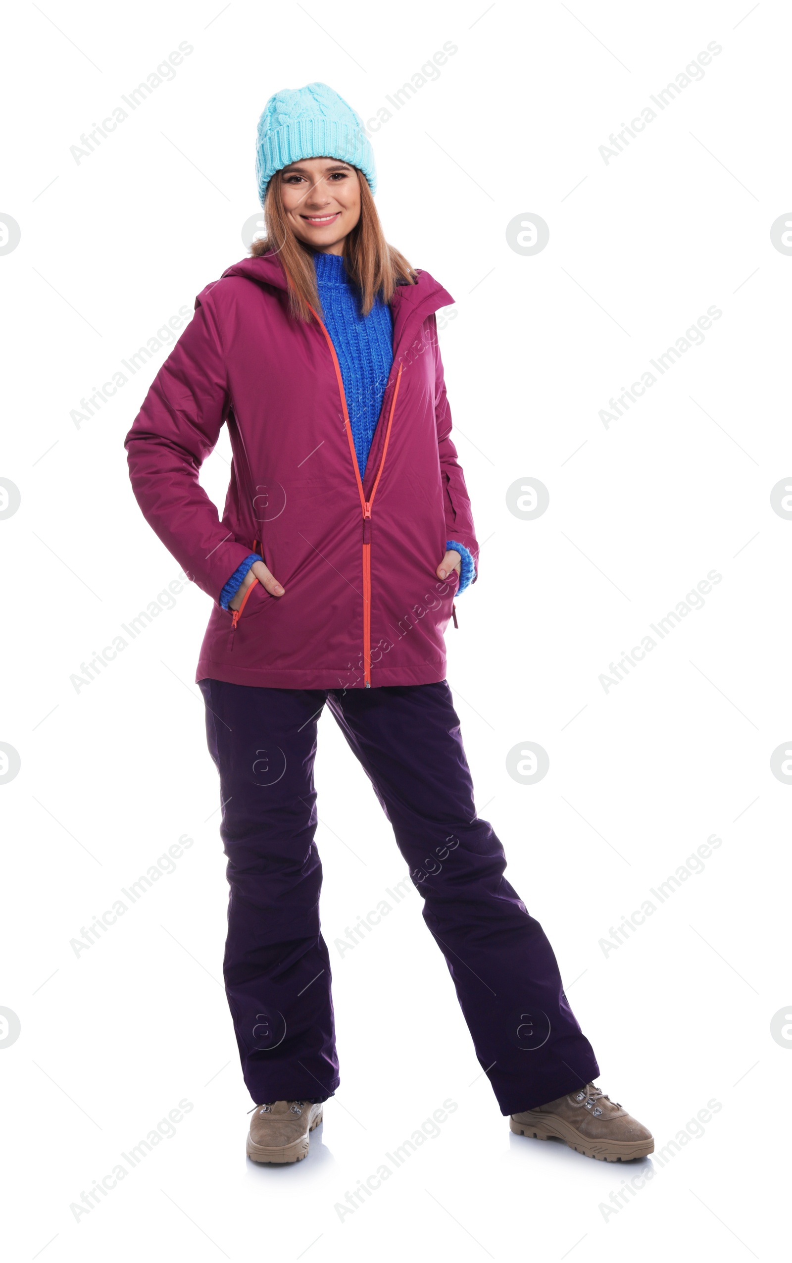 Photo of Young woman wearing warm clothes on white background. Ready for winter vacation