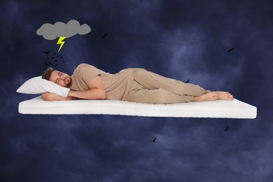 Nightmare concept. Young man sleeping on mattress in sky with heavy rainy clouds