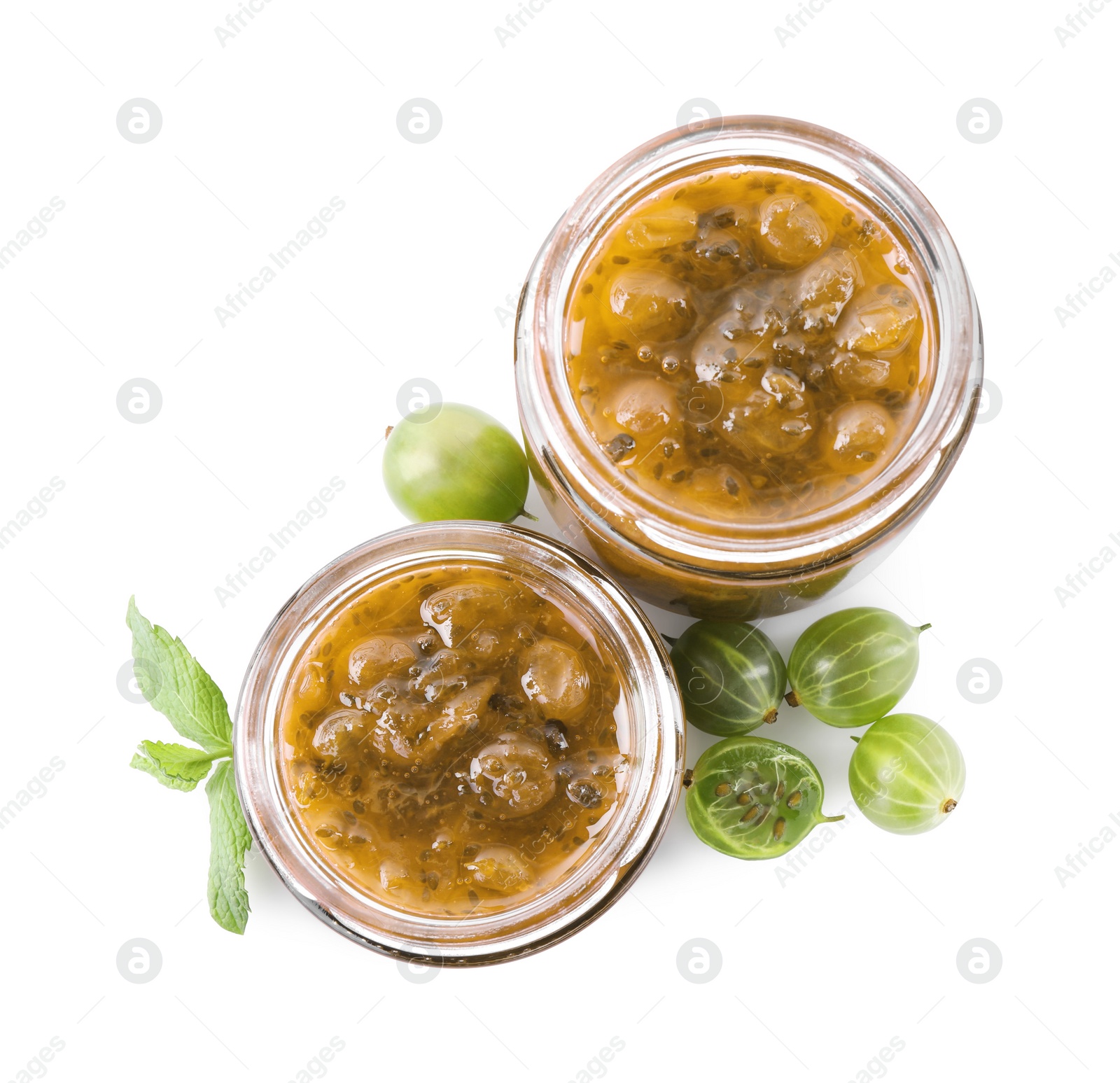 Photo of Jars of delicious gooseberry jam and fresh berries on white background, top view