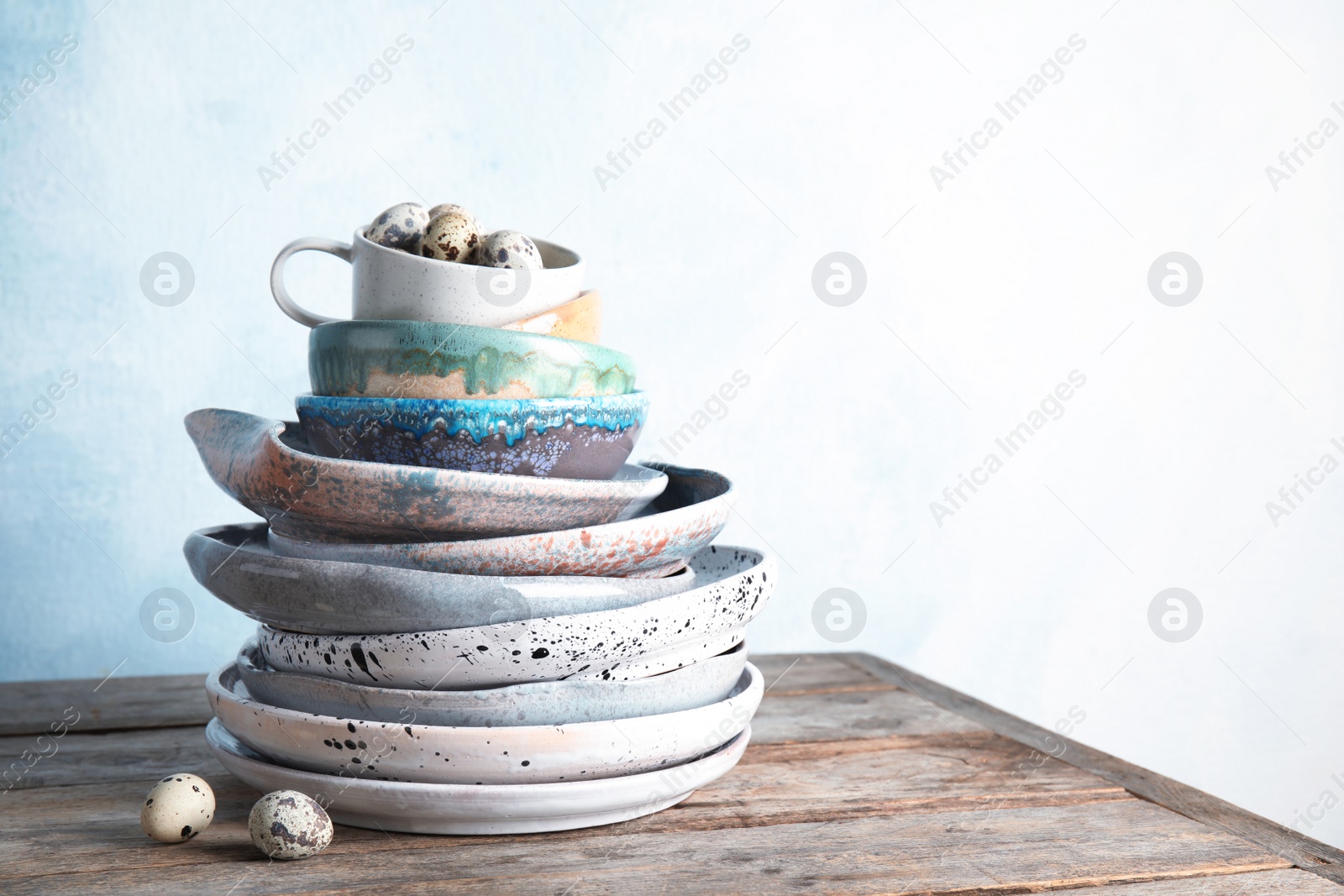 Photo of Composition with dinnerware on table against light background, space for text. Interior element