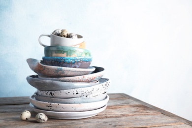 Photo of Composition with dinnerware on table against light background, space for text. Interior element