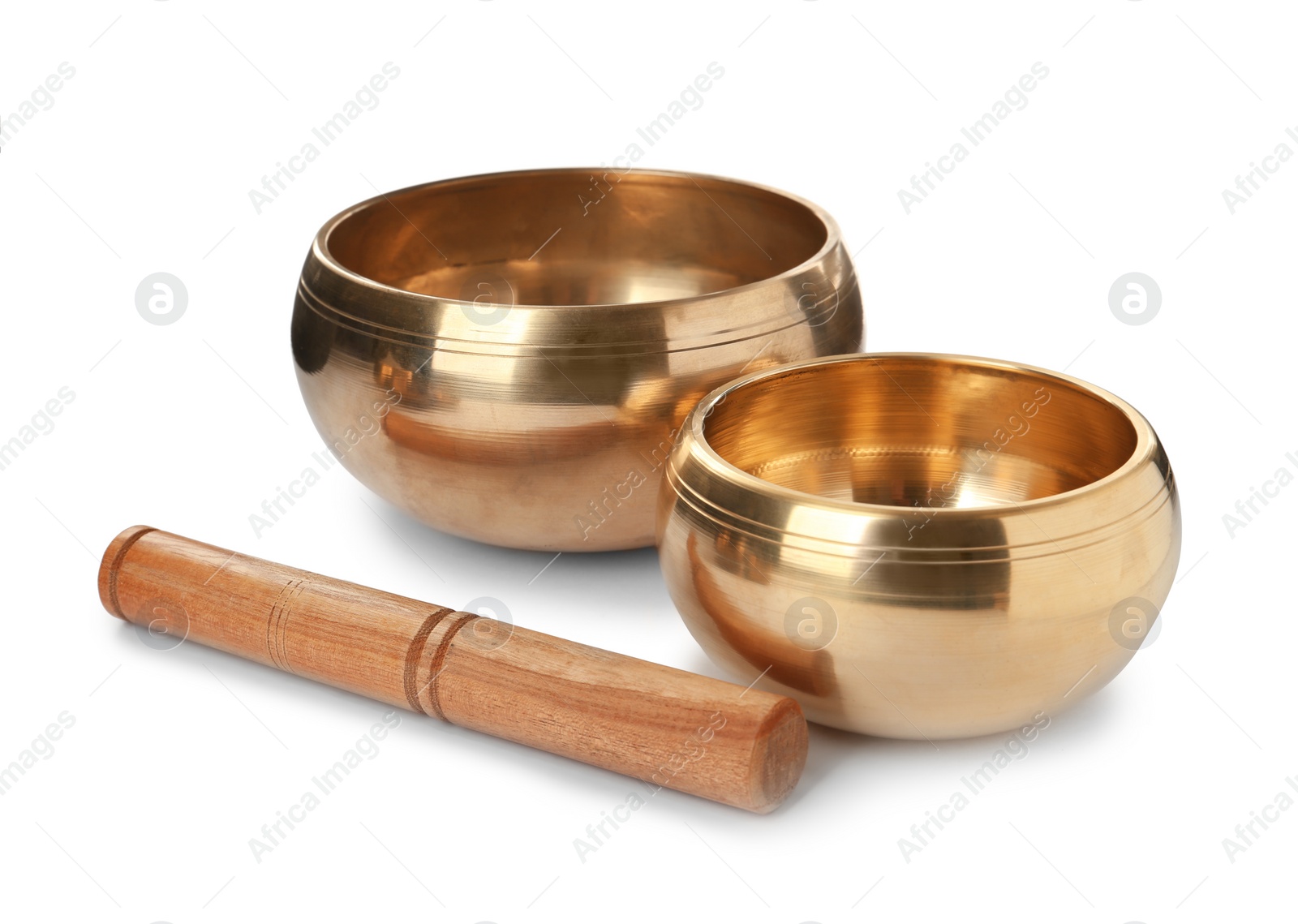 Photo of Tibetan singing bowls and wooden mallet on white background