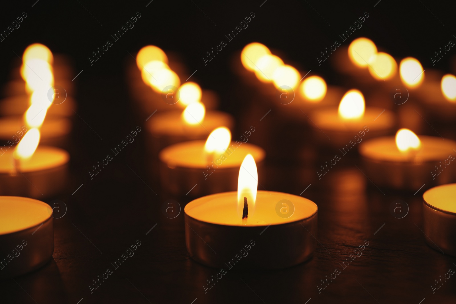 Photo of Many burning candles on table. Memory day