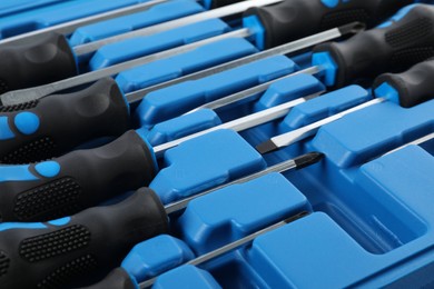 Photo of Set of screwdrivers in toolbox as background, closeup