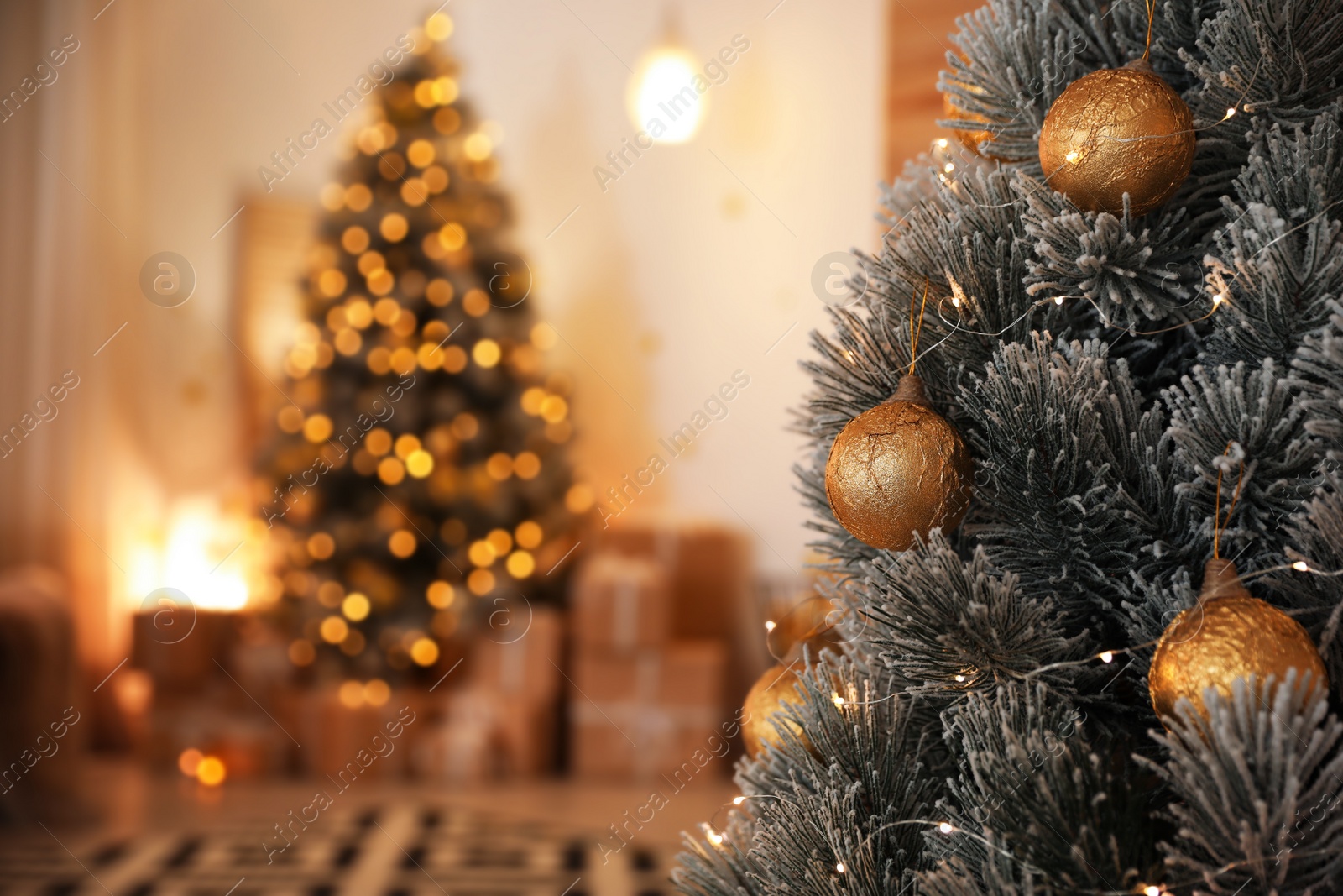 Photo of Beautiful Christmas tree decorated with balls in stylish room interior, closeup