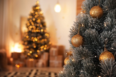 Beautiful Christmas tree decorated with balls in stylish room interior, closeup