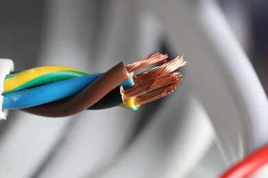 Photo of Colorful electrical wire on blurred background, closeup