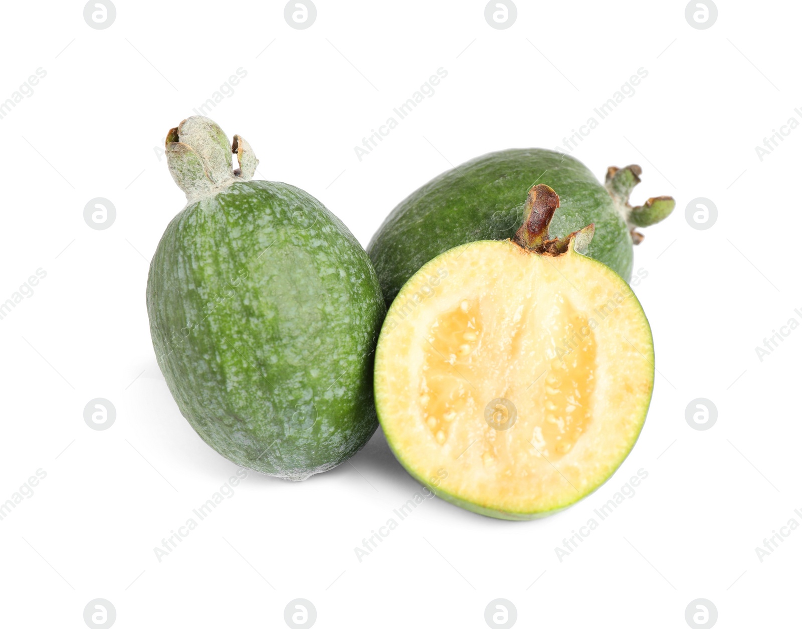 Photo of Cut and whole feijoas on white background