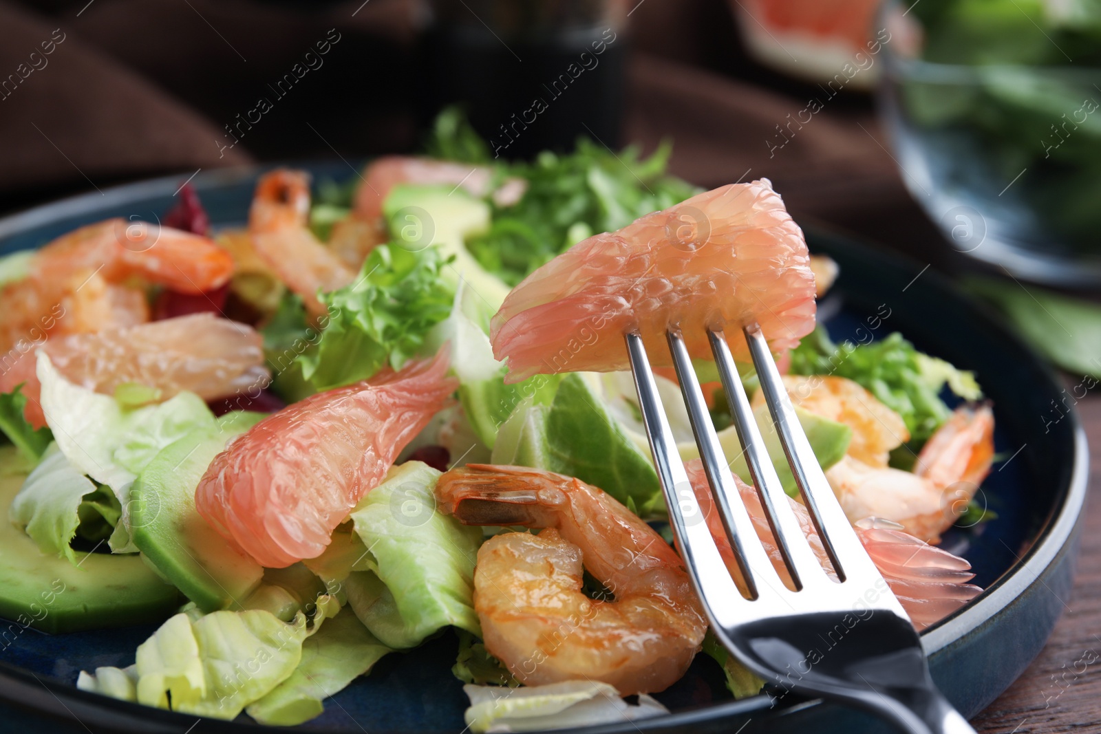 Photo of Delicious pomelo salad with shrimps served on table, closeup