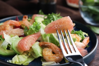 Delicious pomelo salad with shrimps served on table, closeup