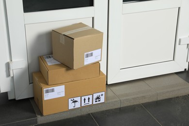 Cardboard boxes on floor near entrance. Parcel delivery service